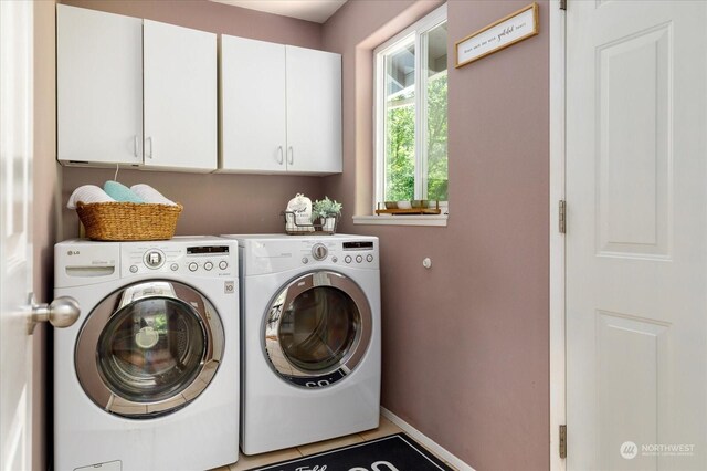 laundry room with cabinets and washer and dryer