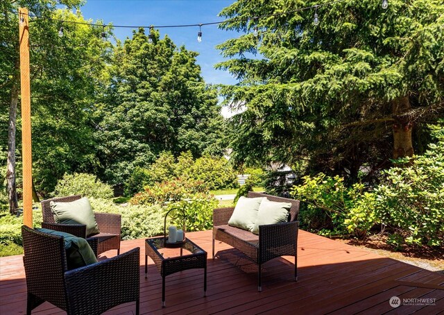 wooden deck with an outdoor living space