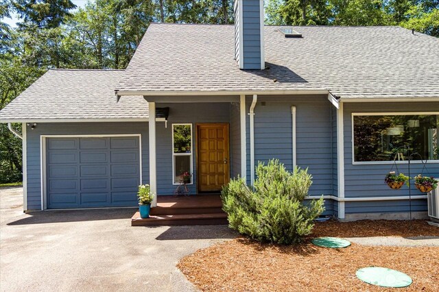 cape cod-style house featuring a garage