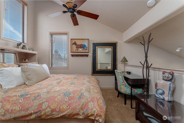 carpeted bedroom featuring lofted ceiling with beams and ceiling fan