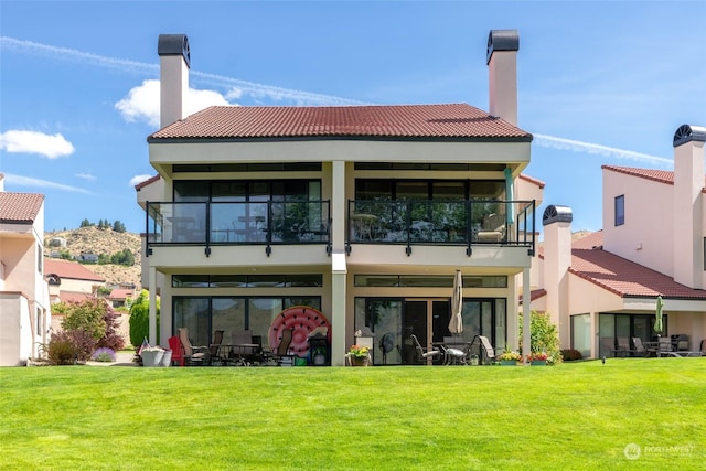 rear view of property featuring a yard