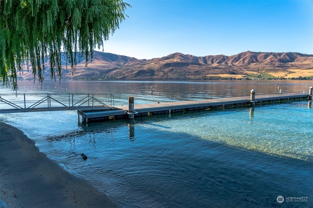 view of dock featuring a water and mountain view