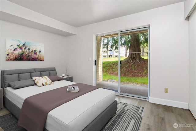 bedroom featuring light hardwood / wood-style floors and access to outside