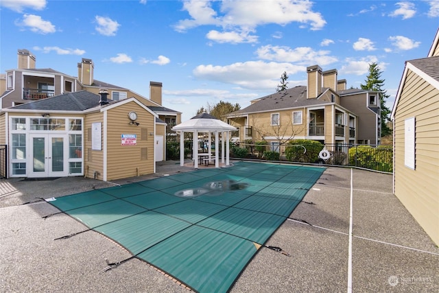 view of swimming pool with a gazebo, a patio, and french doors