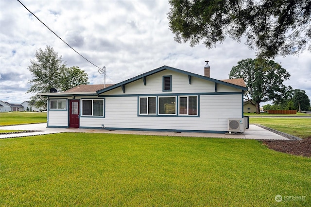 view of front facade with ac unit and a front lawn