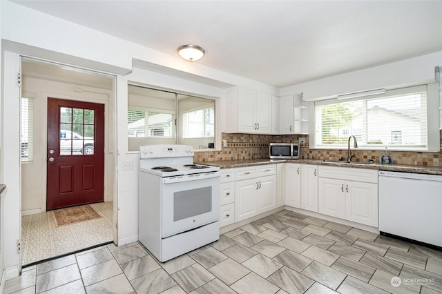 kitchen with a healthy amount of sunlight, white cabinetry, white appliances, and sink