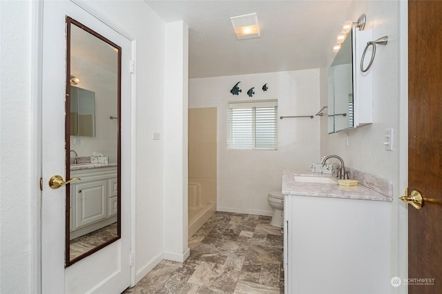 bathroom with walk in shower, vanity, and toilet