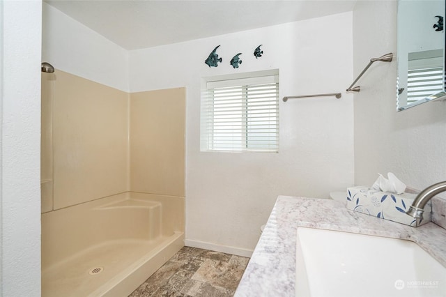 bathroom with vanity and walk in shower