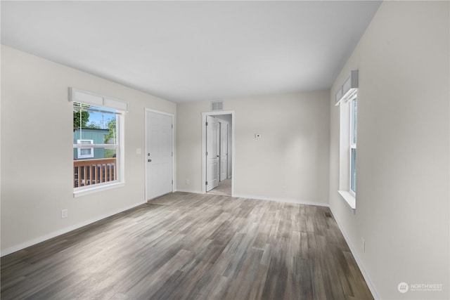 unfurnished room featuring a healthy amount of sunlight and hardwood / wood-style floors