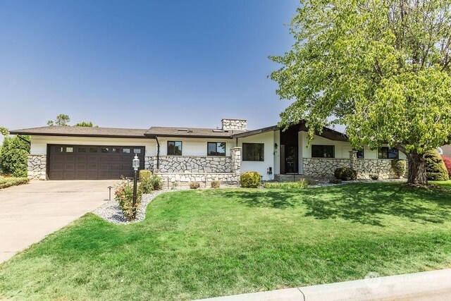 ranch-style home featuring a garage and a front yard