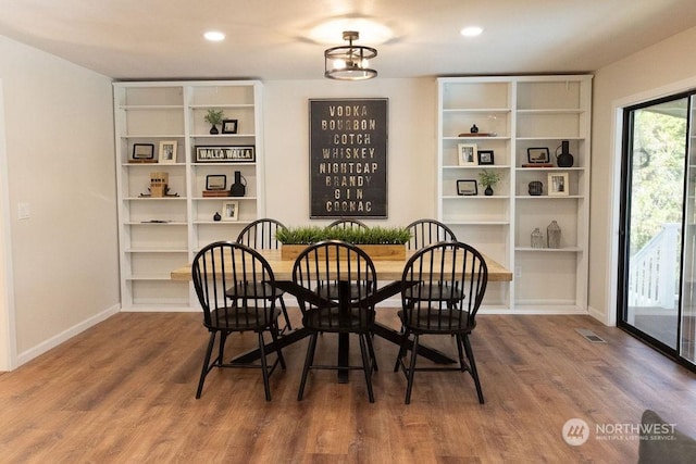 dining area with hardwood / wood-style floors