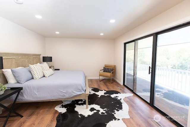 bedroom with hardwood / wood-style flooring and access to outside