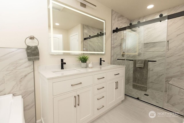 bathroom featuring vanity and a shower with door