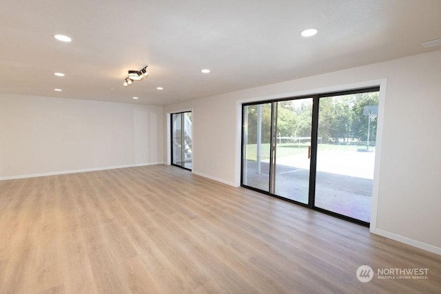 unfurnished room with light hardwood / wood-style flooring