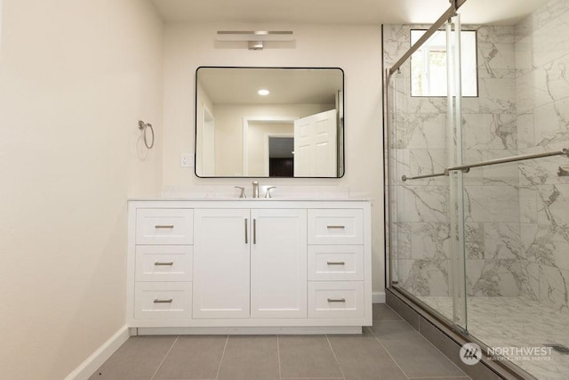 bathroom featuring tile patterned flooring, vanity, and a shower with shower door