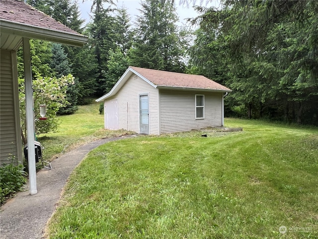 view of outbuilding featuring a lawn