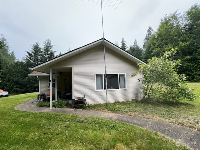 view of side of property with a lawn