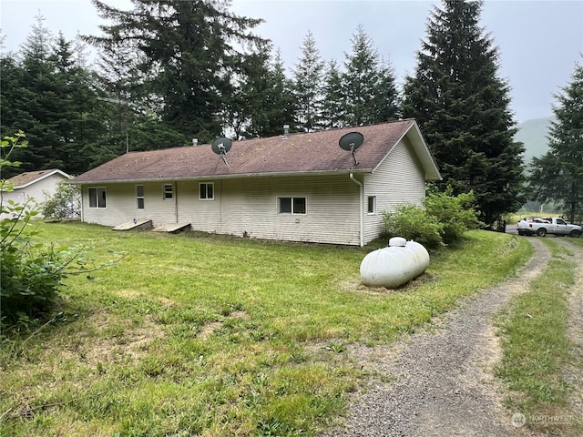 rear view of house featuring a lawn