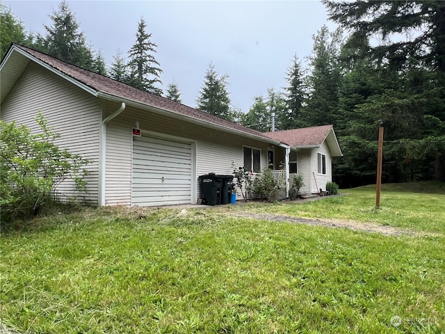 view of home's exterior with a garage and a lawn