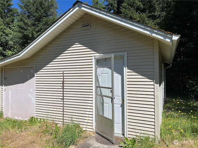 view of side of property with a storage unit