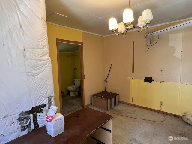 interior space featuring concrete flooring and a chandelier