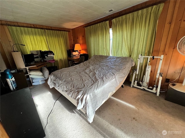 bedroom featuring carpet and wooden walls