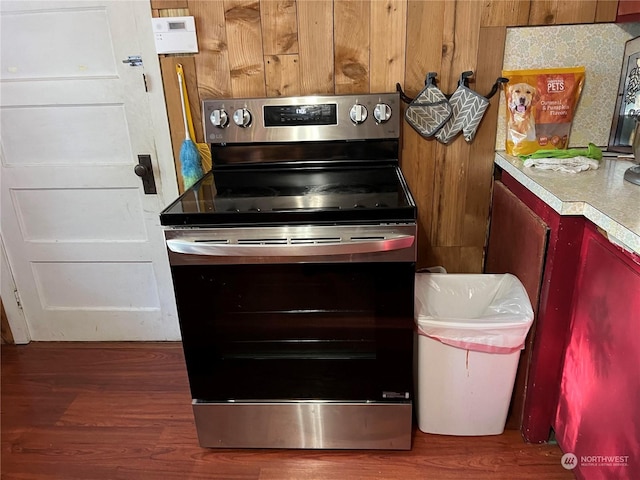 kitchen with electric stove and dark wood-type flooring