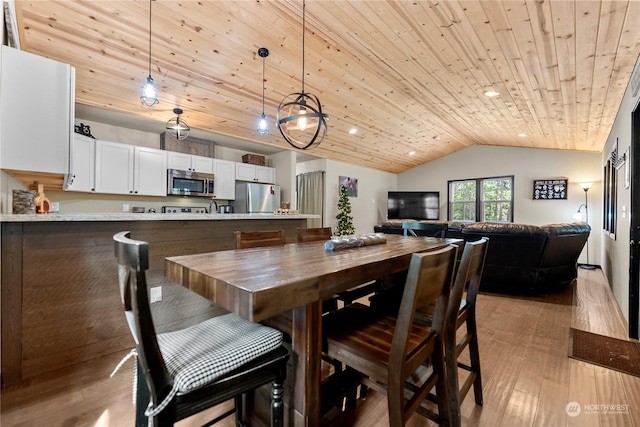 dining room featuring lofted ceiling, wooden ceiling, and light hardwood / wood-style flooring