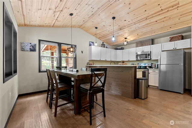 dining room with sink, light hardwood / wood-style flooring, lofted ceiling, and wood ceiling