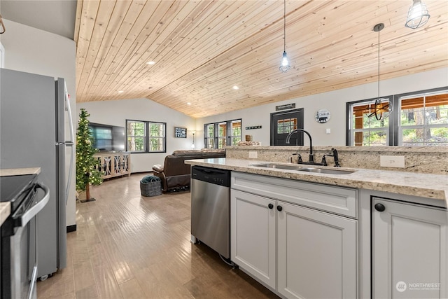 kitchen with wooden ceiling, sink, appliances with stainless steel finishes, decorative light fixtures, and light stone counters