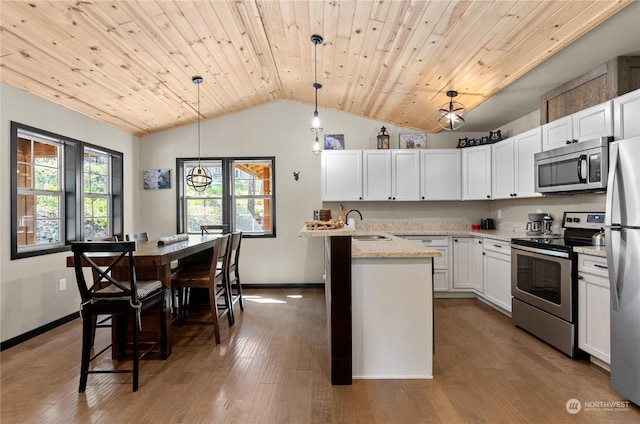 kitchen featuring light stone countertops, wooden ceiling, pendant lighting, white cabinets, and appliances with stainless steel finishes