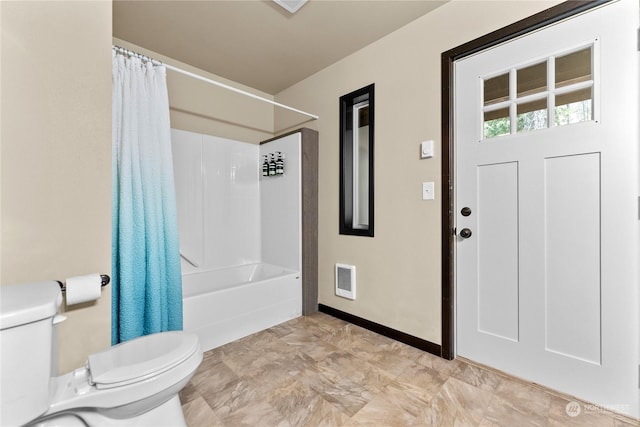 bathroom featuring shower / bath combo and toilet