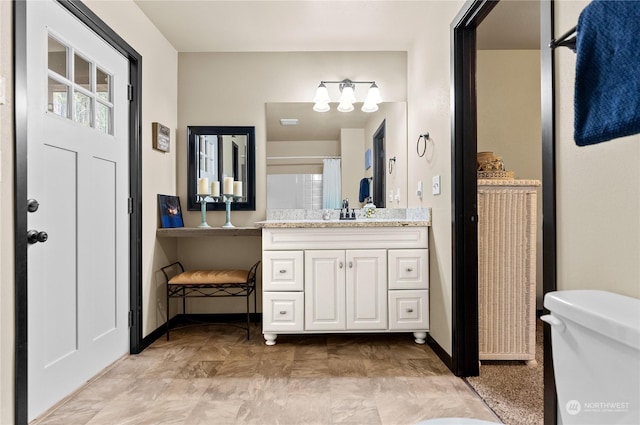 bathroom with vanity and toilet