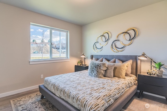 bedroom featuring baseboards and wood finished floors