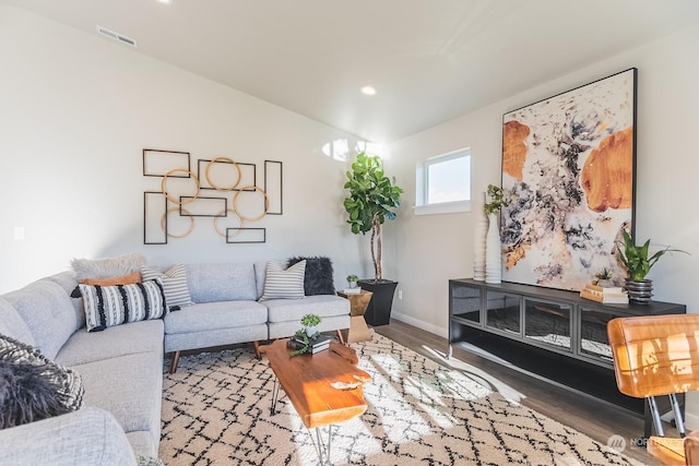 living room with dark wood-style flooring, recessed lighting, visible vents, and baseboards