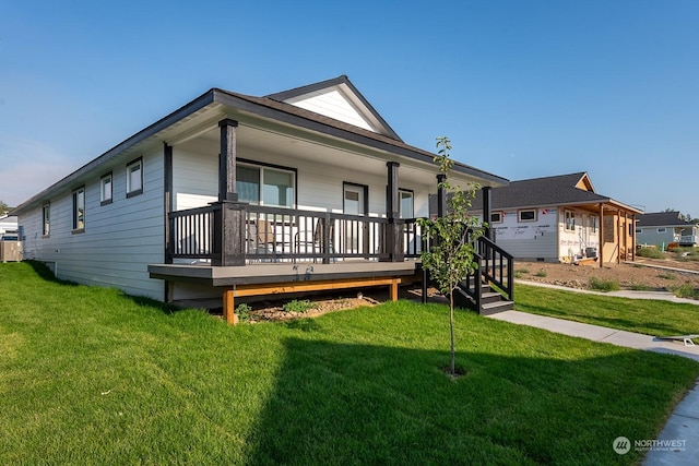 view of front of house with a front yard and covered porch