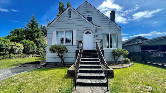 bungalow-style home featuring a chimney, stairs, a front lawn, and fence