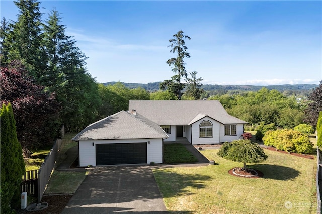 ranch-style house with a garage and a front lawn