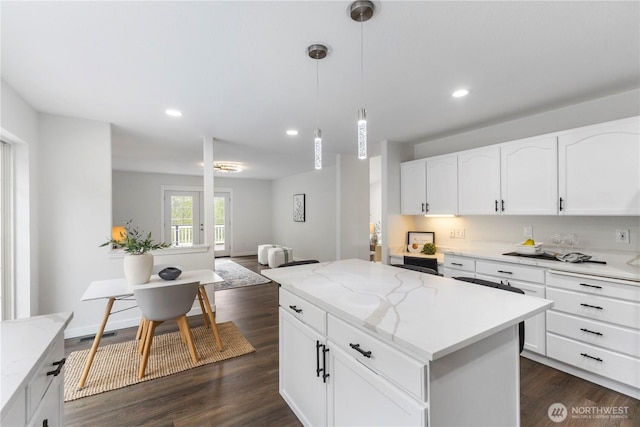 kitchen featuring light stone counters, a kitchen island, and dark wood-style flooring