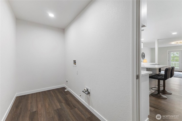 clothes washing area with baseboards, hookup for a washing machine, dark wood-style flooring, and gas dryer hookup