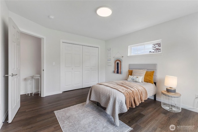 bedroom featuring radiator heating unit, baseboards, a closet, and wood finished floors