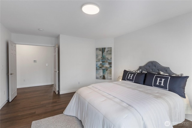 bedroom featuring baseboards and wood finished floors