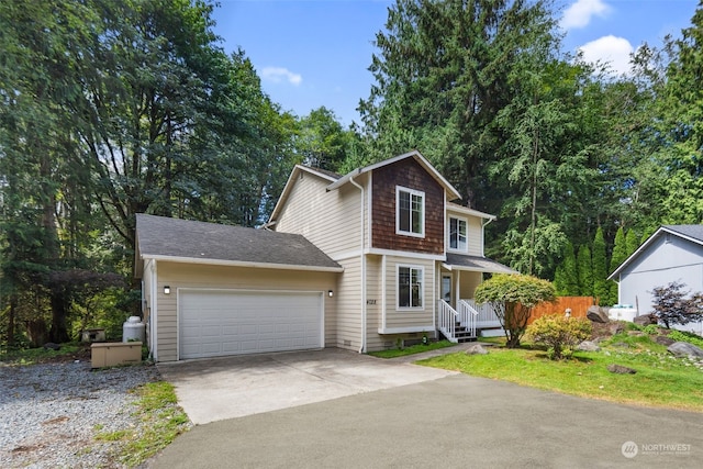 view of front facade with concrete driveway, covered porch, and an attached garage