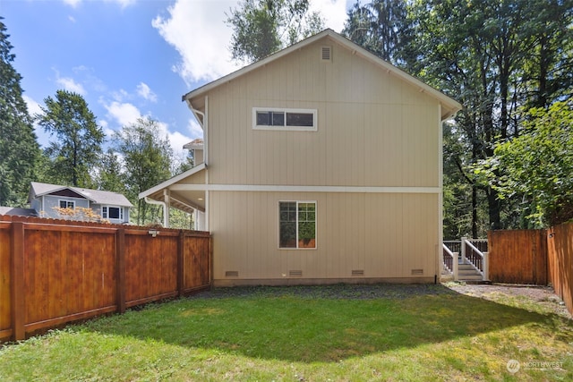 view of home's exterior featuring crawl space, a fenced backyard, and a yard