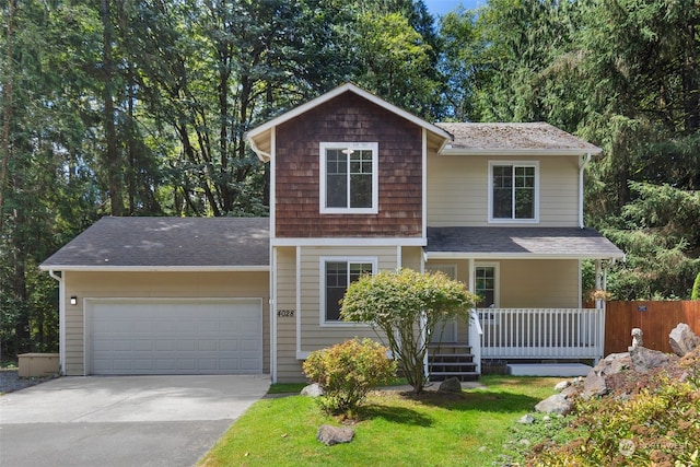 view of front facade featuring an attached garage, covered porch, driveway, and a shingled roof