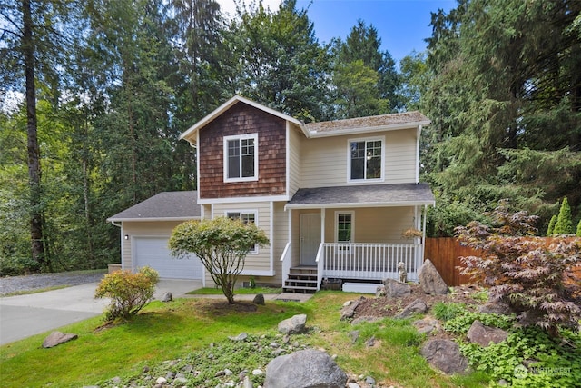 view of front of house featuring driveway, covered porch, a garage, and fence