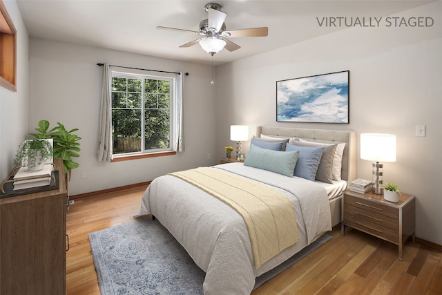 bedroom with baseboards, light wood-style flooring, and ceiling fan