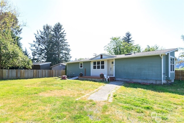 rear view of house with a patio area and a lawn