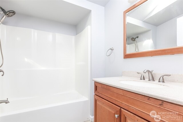 bathroom featuring vanity and shower / tub combination