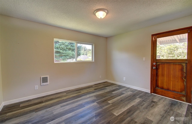 foyer with dark hardwood / wood-style floors and a textured ceiling